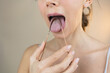 Person Scraping Tongue with Copper Tongue Scraper Oral Care Oral Hygiene Ayurveda