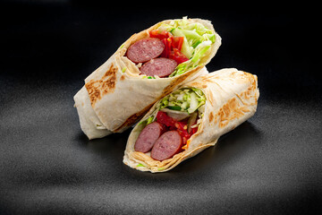 Canvas Print - Shawarma with grilled sausage, vegetables and tomato sauce. Sausage in pita.