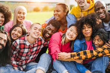 Young diverse people having fun outdoor laughing together - Focus on bald girl face