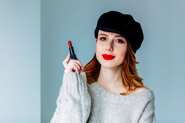 woman in sweater and hat with lipstick