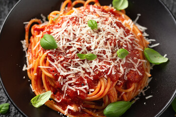 Wall Mural - Italian marinara sauce spaghetti pasta served with fresh basil, olives and pecorino cheese