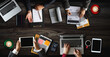 © Nuttapong punna - Top view of business Group of Multiethnic Busy People meeting with other in modern office with laptop computer, smartphone, tablet, coffee and document on table.