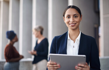 Canvas Print - My favourite get it done gadget. a young businesswoman using a digital tablet against a city background.