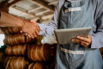 Wall Mural - close up of a hand shake between seller and customer in handicraft workshop