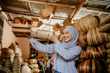 Wall Mural - muslim young female taking picture of her product to sell online