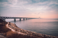 The Oresund Bridge Is A Combined Motorway And Railway Bridge Between Sweden And Denmark (Malmo And Copenhagen). Captured On A Foggy Spring Day Before Sunset.