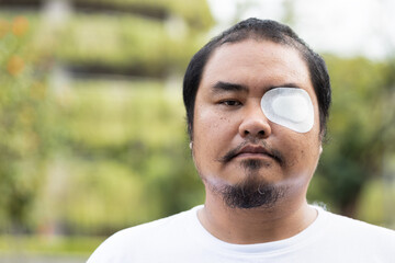 asian middle-aged man patient with eye patch, eye sight impair