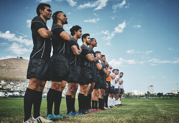 Canvas Print - Standing tall for our team. a team of confident young rugby players standing at attention singing their anthem outside on a field before a rugby match.