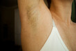 Hair on a woman's armpit. Concept of body naturalness self love. Hair removal.Armpit stubble.

