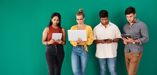 Poster - Stay connected to your office with the right business tools. a group of young designers using digital devices while standing together against a green background.