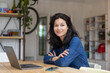 © ReeldealHD images - Mid adult asian female working on personal finances using a laptop and a smartphone