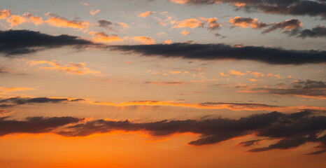 a fabulously beautiful summer sunset. dark clouds in yellow and orange colours. the sun's rays from 