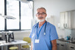 © Halfpoint - Portrait of elderly doctor at hospital room.