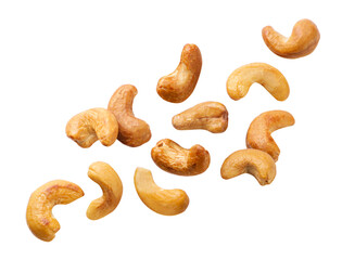 Wall Mural - Roasted cashews flying on a white background. Isolated