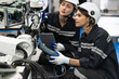 © chachamp - Two Engineer caucasian woman use remote control checking arm robot in the machine lap