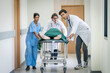 © nuttawutnuy - Doctor team and nurse staff carrying stretcher with patient from the accident ambulance running to the surgery room in hospital