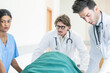 © nuttawutnuy - Doctor team and nurse staff carrying stretcher with patient from the accident ambulance running to the surgery room in hospital