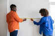 © Prostock-studio - Black Couple Measuring Wall With Tape Ruler While Making Repairing At Home