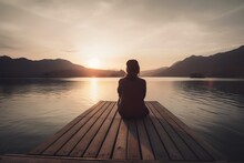  A Person Sitting On A Dock Looking Out Over A Lake At Sunset Or Sunrise Or Sunset, With Mountains In The Distance, And A Boat In The Foreground.  Generative Ai