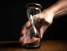A Hand Holding A Ticking Hourglass Showing The Urgency And Importance Of Staying On Top Of Business Deadlines.. AI Generation.