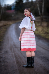Wall Mural - Young beautiful slovak woman in traditional dress. Slovak folklore