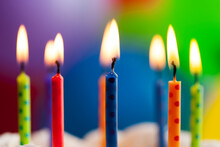 Close Up Of Candle Flame Against Colorful Balloon Background