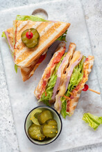 Club Sandwich With Ham, Cheese, Tomatoes, Lettuce, And Toasted Bread