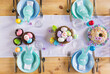 Easter table setting with painted eggs. Easter cake and cutlery on the festive table
