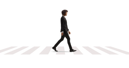 Full length profile shot of a young african american man in a suit and tie crossing street