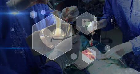 Poster - Animation of medical icons over mid section of team of surgeons performing operation at hospital