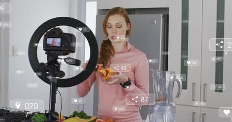 Poster - Animation of social media icons over caucasian female blogger making fruit juice in front of camera
