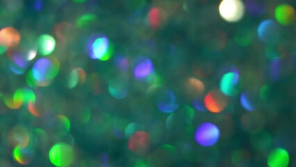 Canvas Print - Green Bokeh With Rainbow Light Reflexes. Abstract glow defocused circles moving background. Multicolored bokeh lights in motion.
