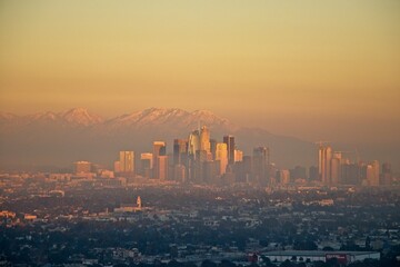 Wall Mural - Snow tops the San Gabriel Mountains that tower above Los Angeles as evening falls on the city.