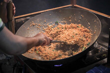 A Man Cooking Fried Rice On Steel Skillet Pan For Selling On The Street Food. Indonesian Call The Dish Nasi Goreng. Indonesian Street Food Culinary