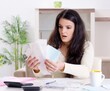© Elnur - Young woman with receipts in budget planning concept