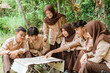 © Odua Images - team leader shows the location to the youth scout group with a map during the briefing