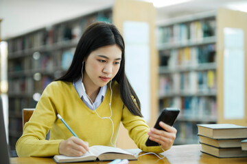 Poster - Student studying at library using phone.