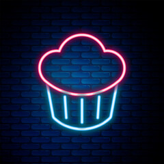 Sticker - Glowing neon line Cupcake icon isolated on brick wall background. Colorful outline concept. Vector