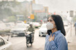 © Deemerwha studio - Asian woman wearing the N95 Respiratory Protection Mask against PM2.5 air pollution and headache Suffocate. City air pollution concept
