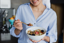 Latin Young Woman In Bathrobe Eating Cereal For Breakfast In Morning Kitchen At Home In Mexico, Hispanic Female