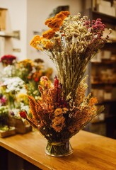 Poster - Bright cheerful dried flowers bouquets standing in vase on table in interior., created with generative ai