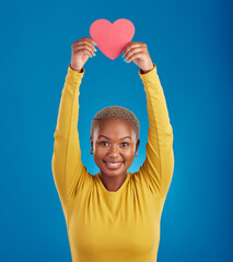 Paper, heart and portrait of black woman in studio for love, date and kindness. Invitation, romance and feelings with female and shape isolated on blue background for emotion, support or affectionate