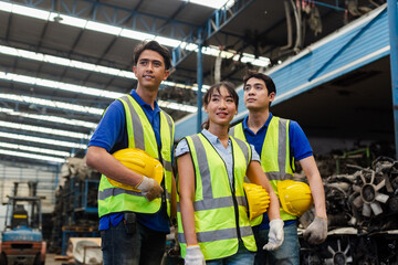 Happy full team engineering worker technician looking at camera, workshop manufacturing, Teamwork in industry factory. Warehouse auto parts