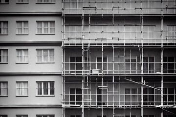 Sticker - Stairs and scaffolding lined up on walls of building for apartment renovation., created with generative ai