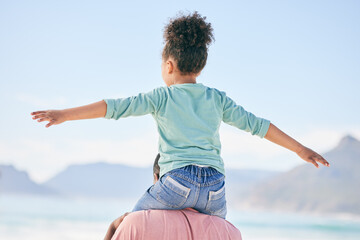 Wall Mural - Beach, black man with child on shoulders from back on playful family holiday in Australia with freedom and fun. Travel, fun and happy father and girl playing, flying and bonding together on vacation.