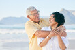 © Charlize D/peopleimages.com - Senior couple at beach, hug and happy with travel, retirement and love outdoor, vacation with view and relax in nature. Peace, zen and tropical island, man and woman with marriage and happiness