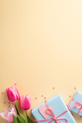 Wall Mural - Mother's Day decorations concept. Top view vertical photo of bunch of pink tulips blue gift boxes with ribbon bows and heart shaped sprinkles on isolated pastel beige background with blank space