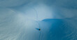 Aerial view of thrilling Snowmobiling Adventure Through Untouched Winter Wonderland