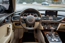 Luxury Modern Car Interior Business Class. Steering Wheel, Shift Lever, Speedometer, Display, Gearbox Handle, And Multimedia Dashboard. Detail Of Car Interior Inside. Automatic Gear Stick. Closeup.
