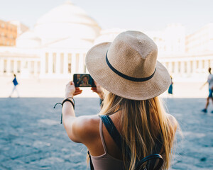 Wall Mural - Young attractive smiling girl tourist exploring new city at summer